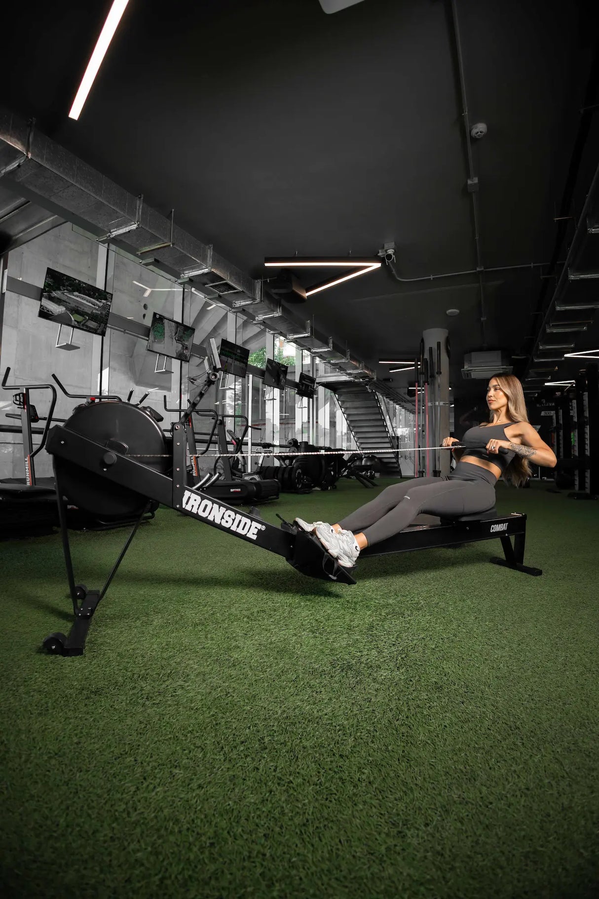 Athlete training on the IRONSIDE Combat Rower — commercial cardio equipment for fitness clubs and universities