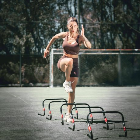 Woman jumping over agility hurdles during a CrossFit and functional training workout - CrossFit and functional fitness equipment Canada
